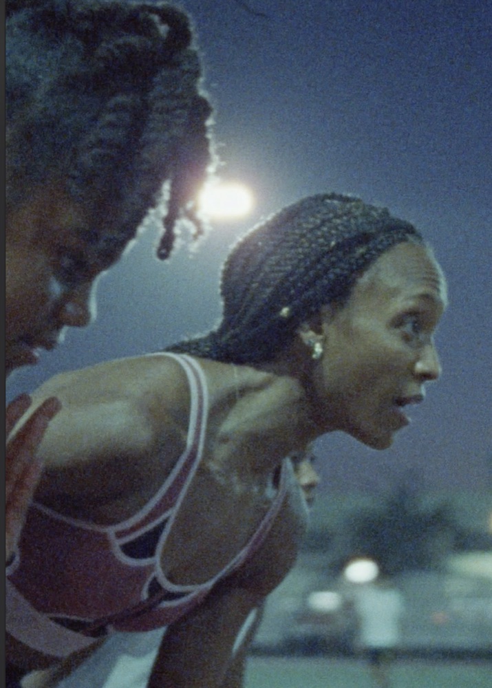 Two athletes at the starting line at dusk, a frame from the Nike Maddox spot.