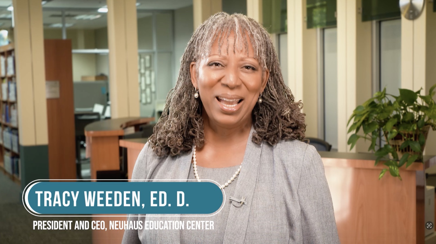 Neuhaus Education Center leader speaking to camera in a library.